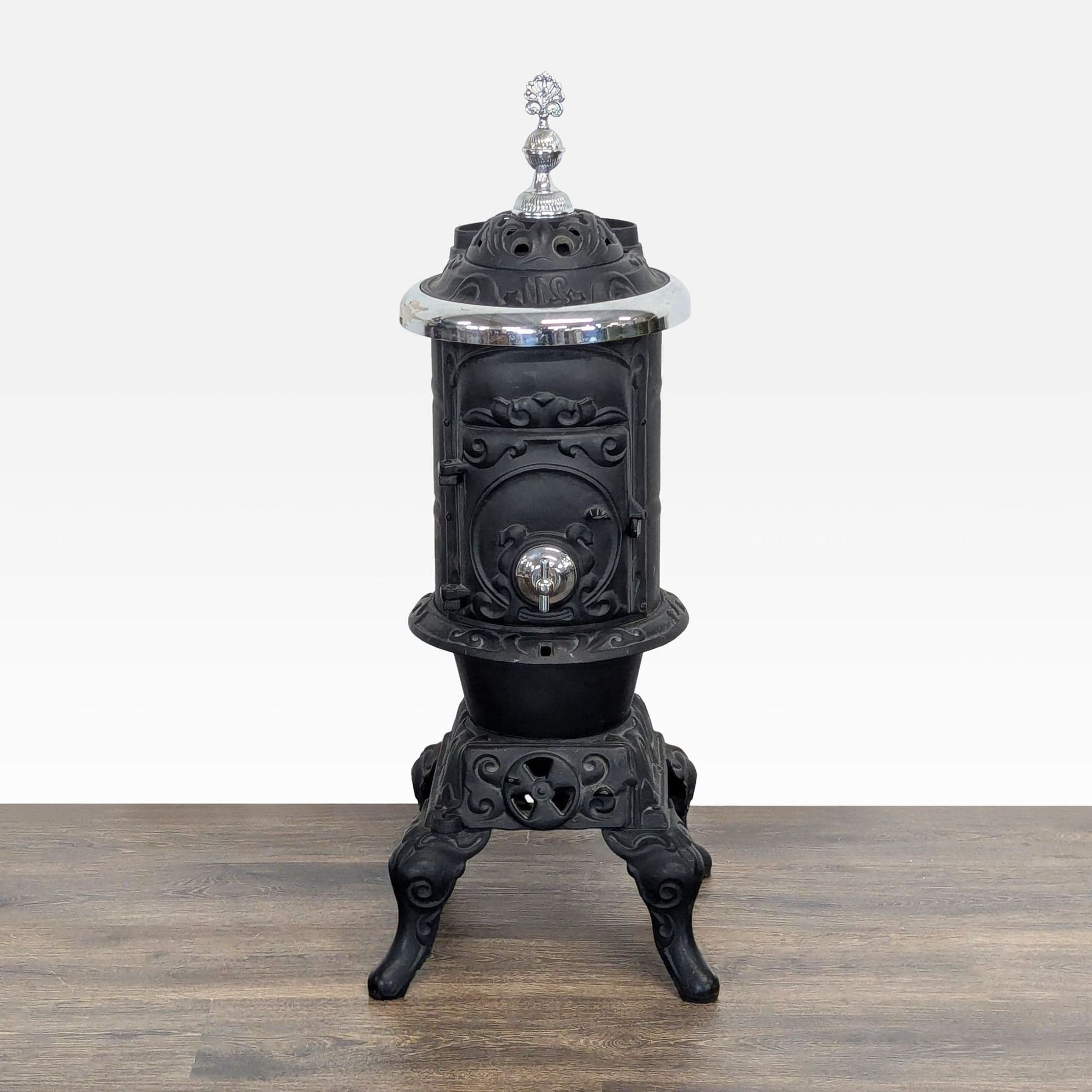 Antique Iron Parlor Stove with Decorative Silver Accents - Image 1