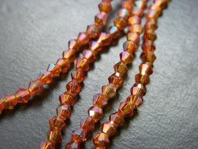 Crafting Glass Beads, Orange Red Bicone (3mm Strand, 18 Inch) - Image 1