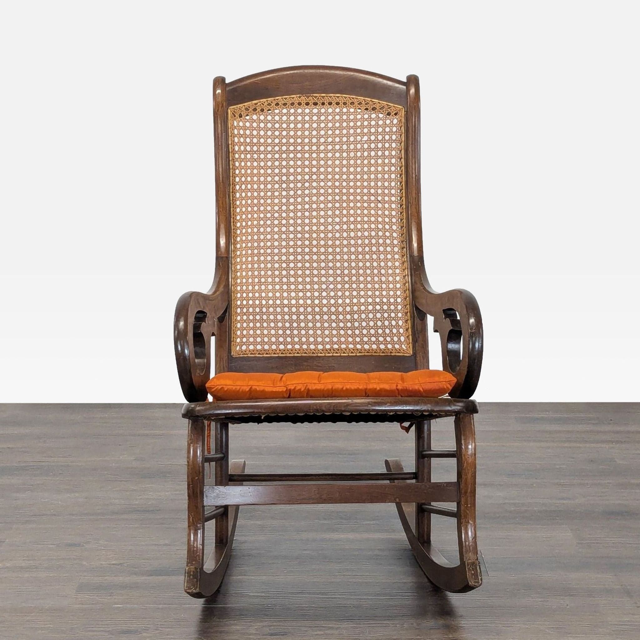 Vintage Bentwood Rocking Chair with Cane Back and Orange Cushion - Image 1