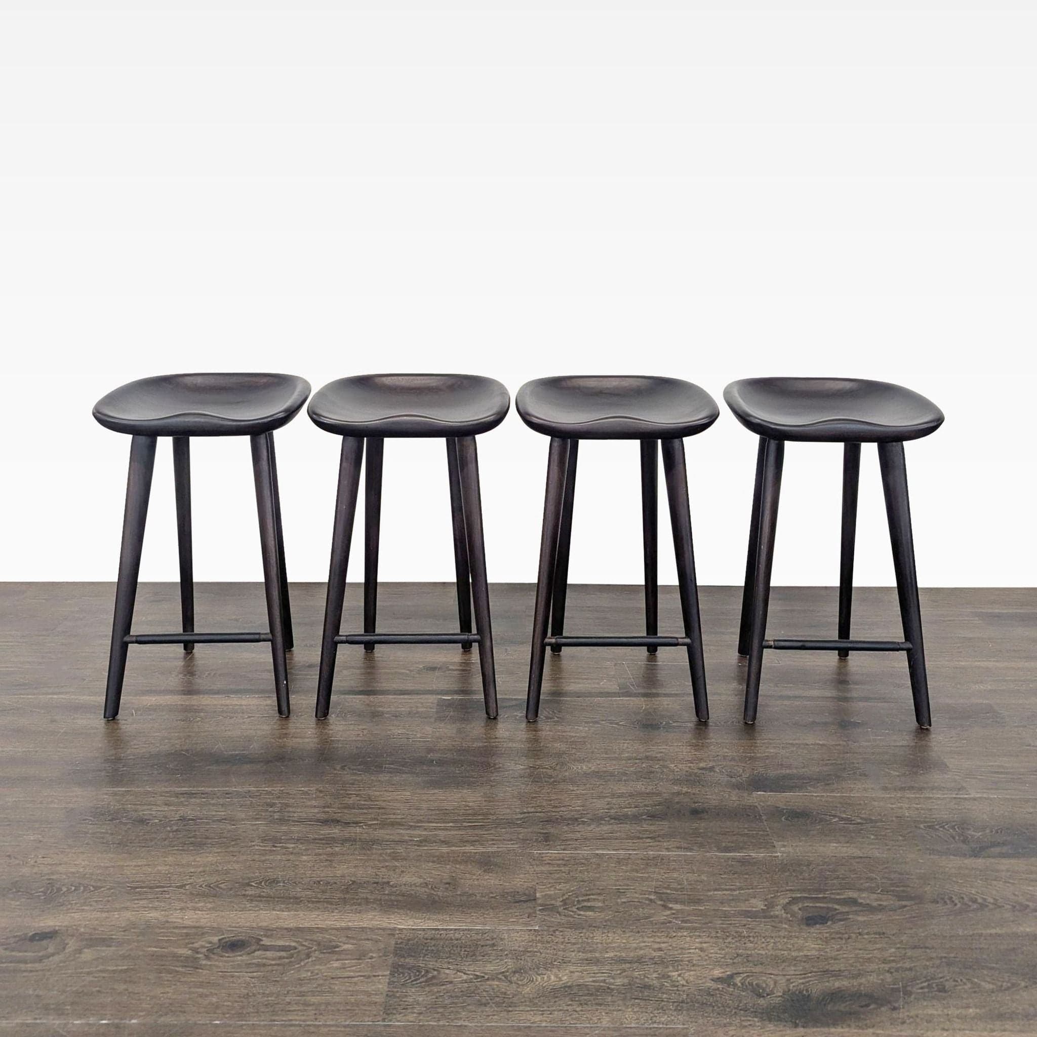 Set of Four Wood Saddle Stools - Image 1