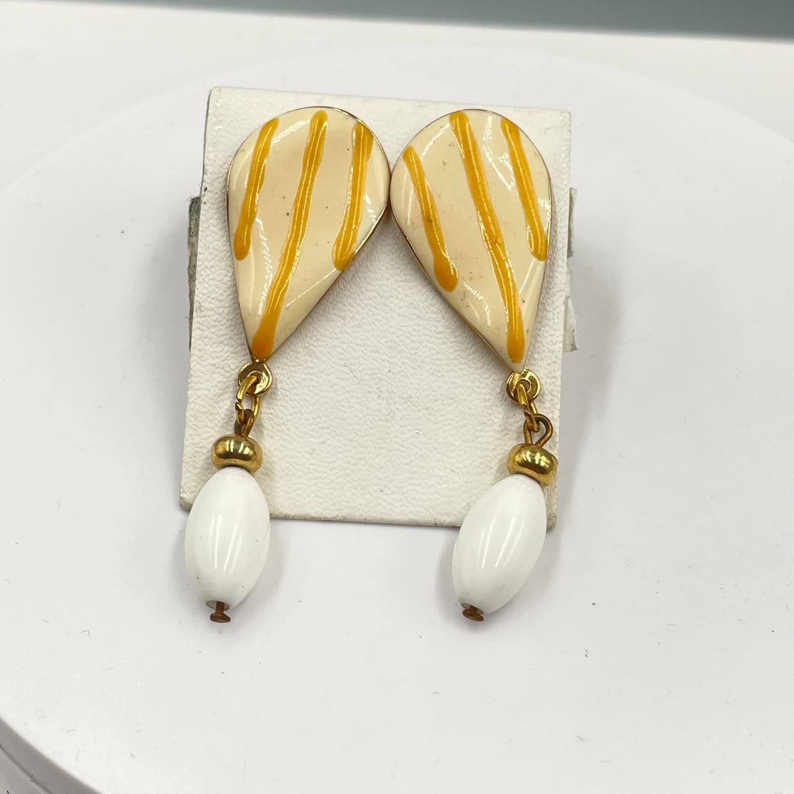 Vintage 1980s Gold-Tone Cream Enamel Striped Teardrop Rice Bead Dangle Earrings - Image 1