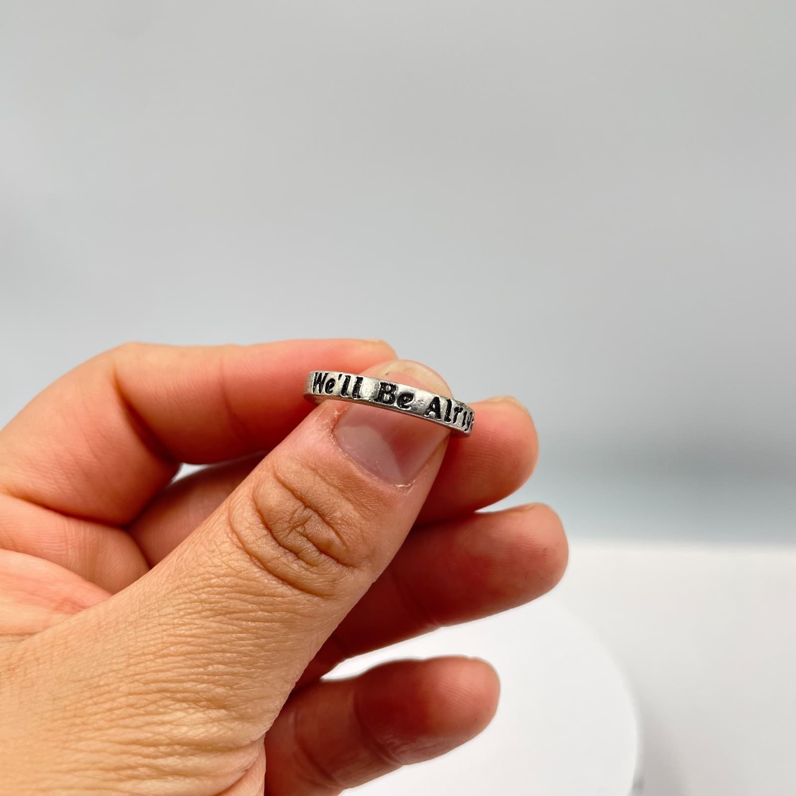 Silver-Tone Engraved Metal "We'll Be Alright" Inscribed "Fine Line" Quote Ring - Image 1