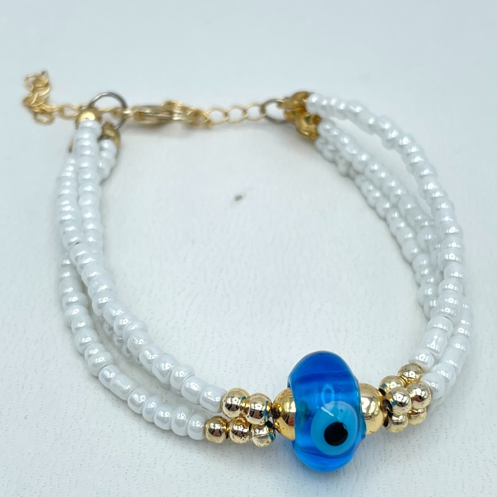 Vintage 90s Gold Tone Triple Strand White Seed Beaded Evil Eye Bracelet Jewelry - Image 1