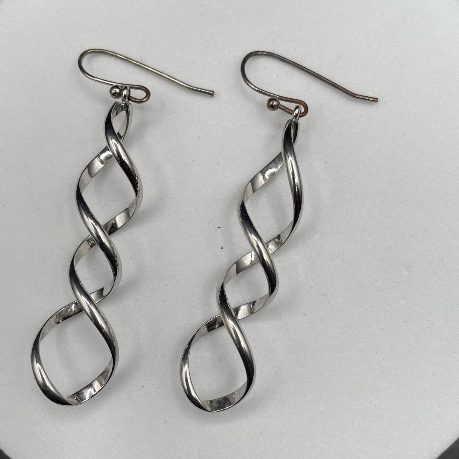 Silver Tone Twisted Ribbon Dangle Earrings Modern Minimalist Chic - Image 1