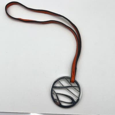 Vintage Silver Tone Cutout Abstract Circle Pendant Necklace Orange Leather Cord - Image 1