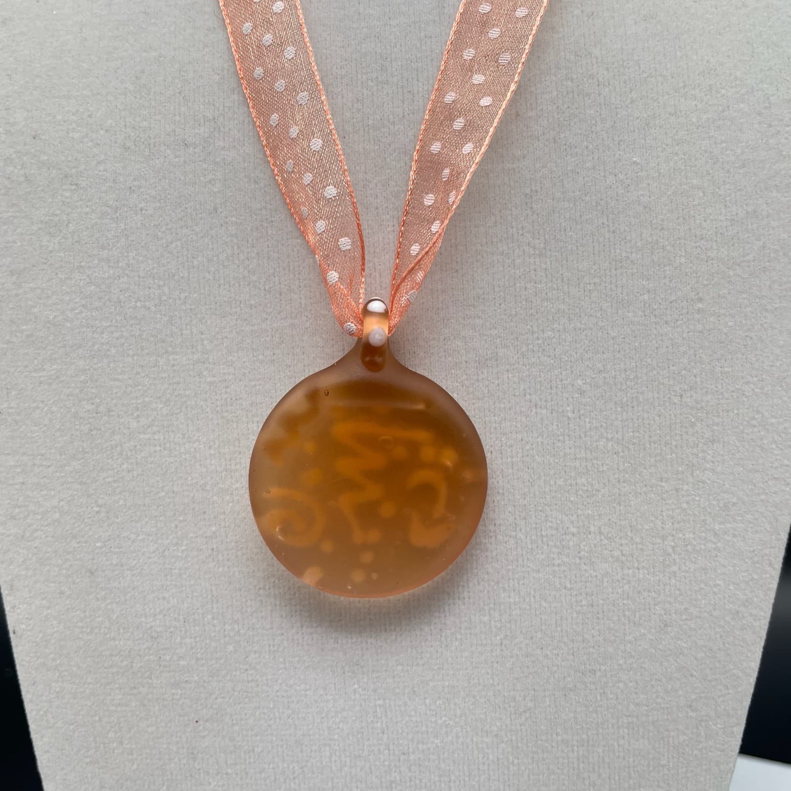Amber & white swirled round glass pendant necklace on sheer polka dot ribbon - Image 1