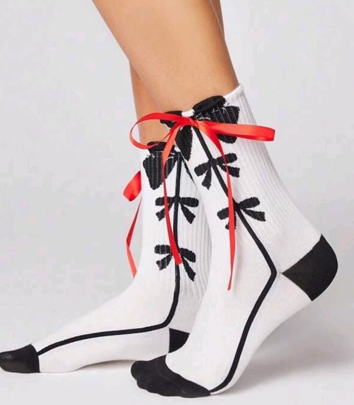 Stylish White Socks with Black Pattern and Red Ribbon - Image 1