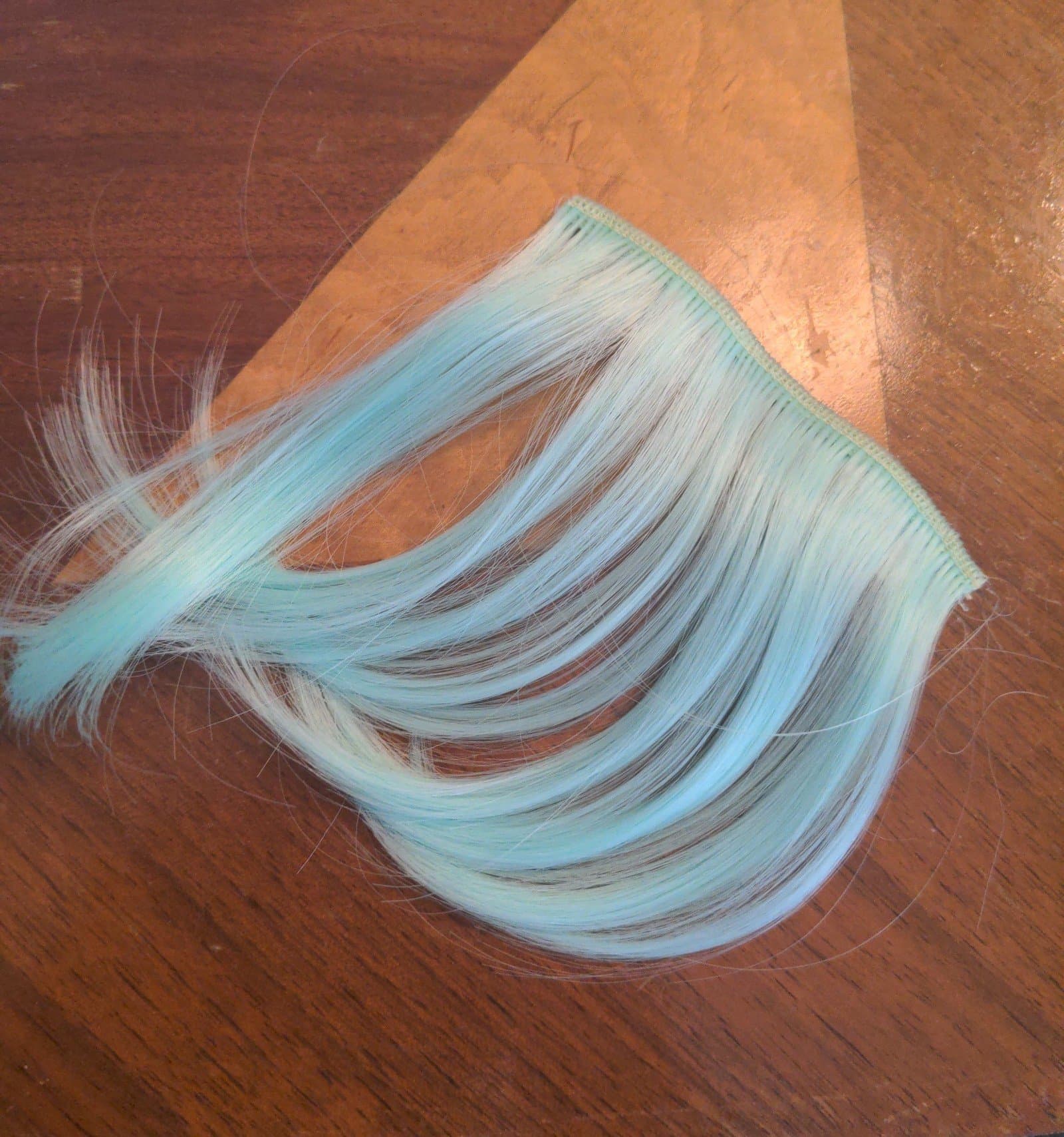 Cotton candy teal clip in bangs - Image 1