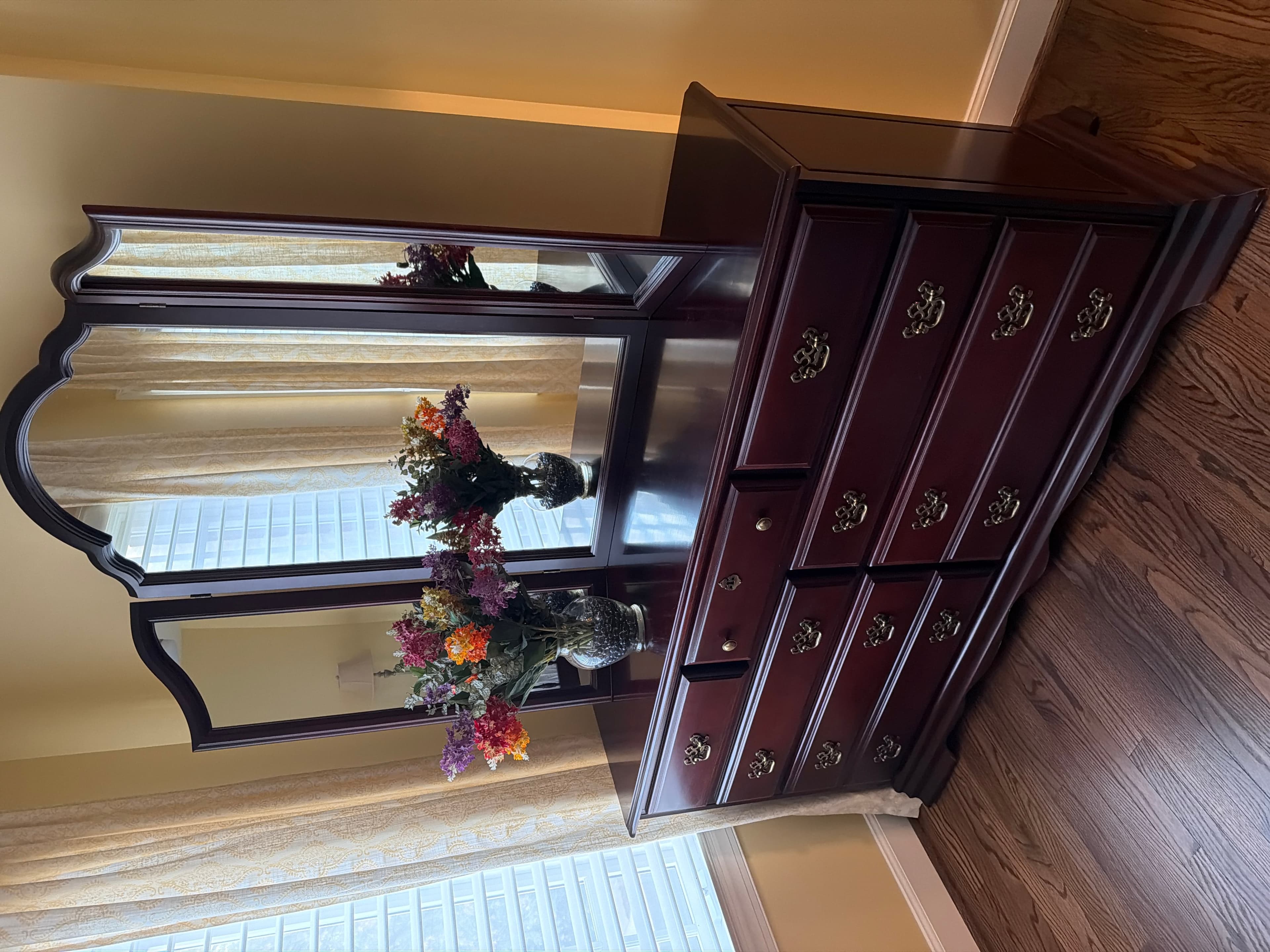 Vintage cherryDresser with Mirror and Floral Arrangement - Image 1