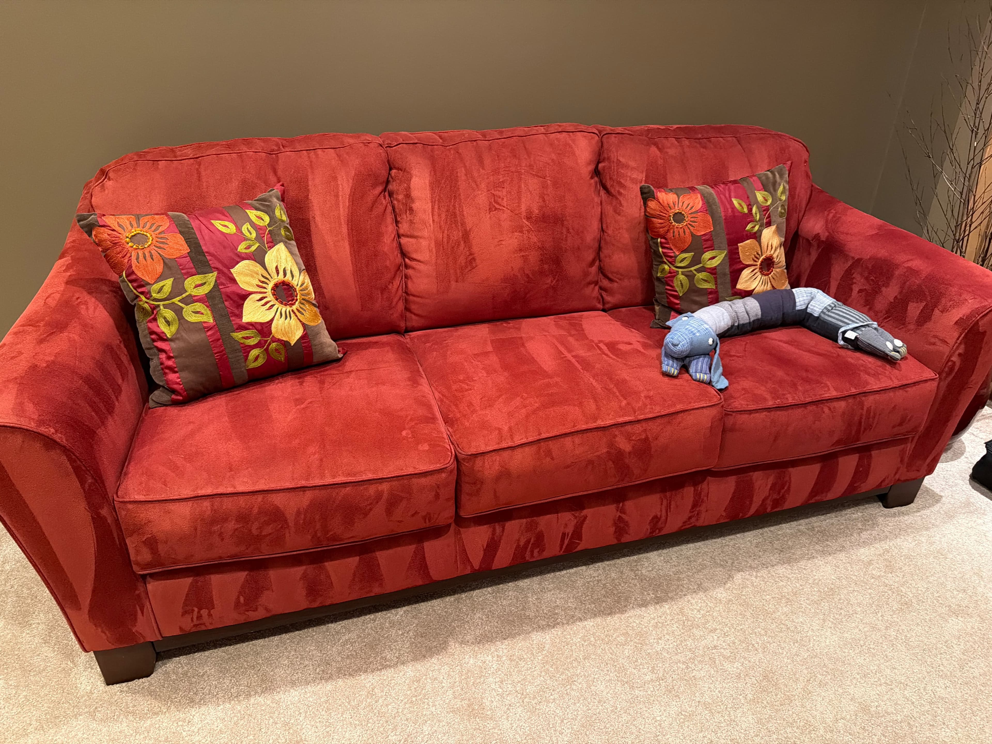 Red Fabric Sofa with Floral Pillows - Image 1