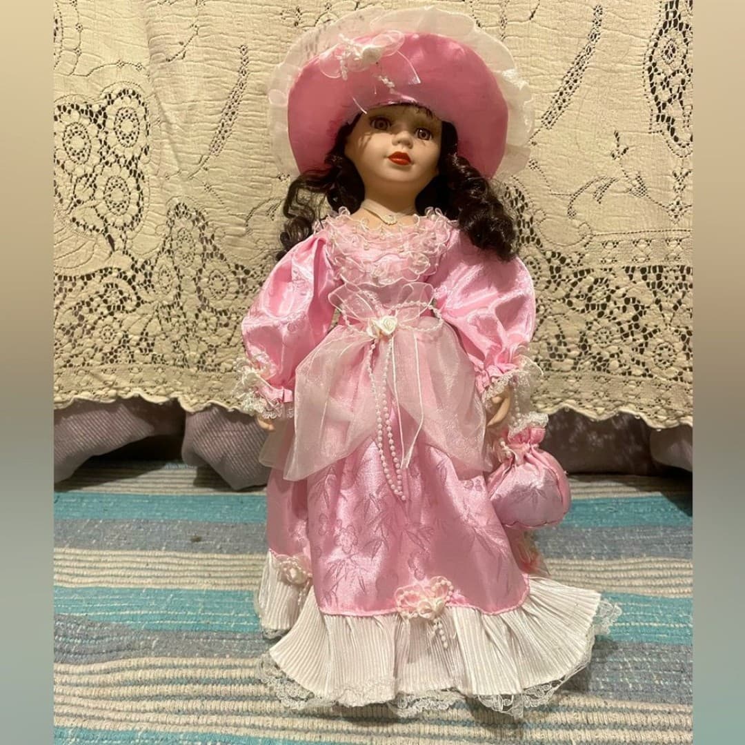 Vintage elegant porcelain doll in pink dress - Image 1