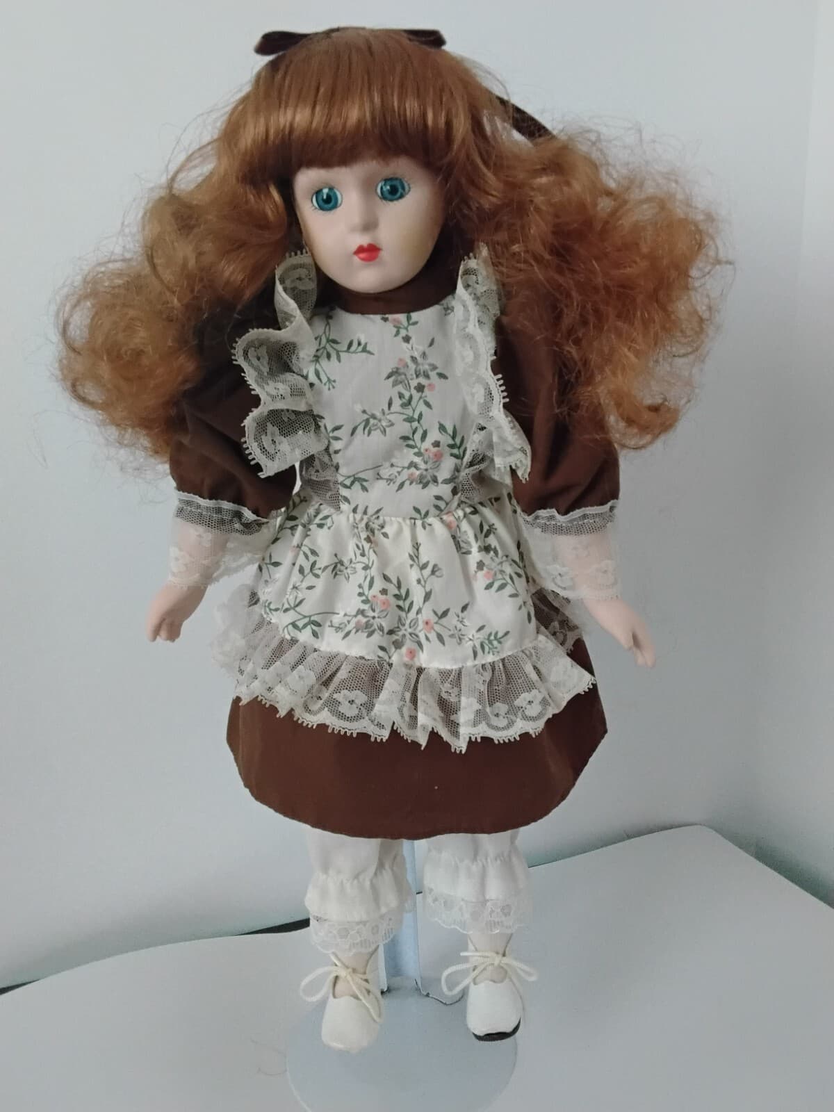 Porcelain collectible doll with auburn hair, brown Victorian style dress/ apron - Image 1