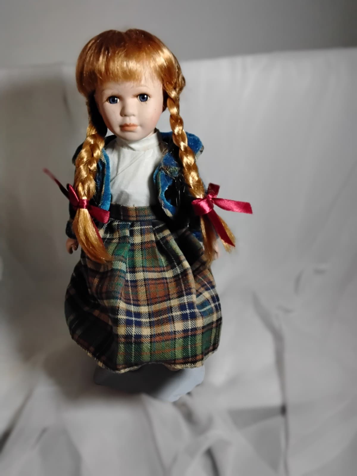 Porcelain Doll With Puppy Face On Her Dress - Image 1