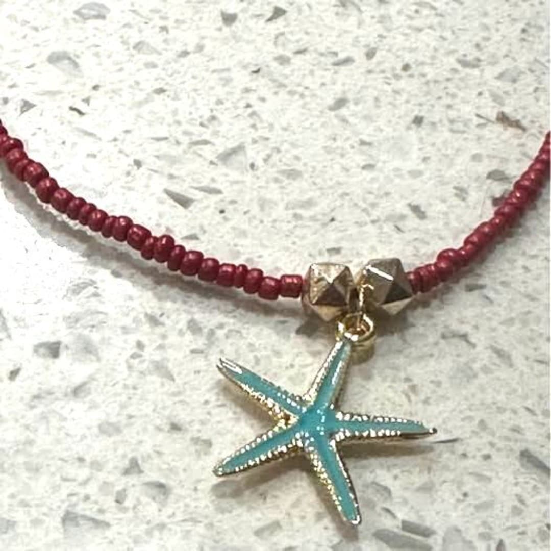 Elegant red beaded necklace featuring a charming starfish pendant. - Thumbnail 3