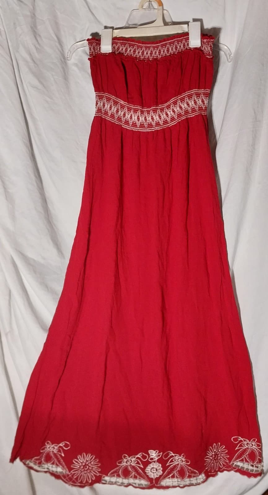 Pinky. Long Red Sleeveless Dress with design at the waist & bottom of dress - Image 1