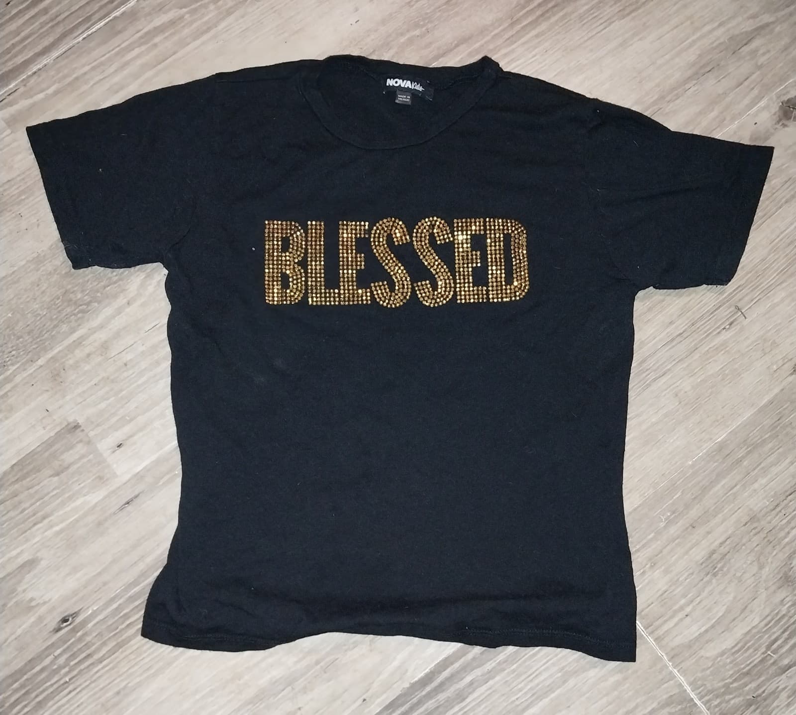 NovaKids. Black Shirt With Graphic "BLESSED" In Gold Lettering on the Shirt - Image 1