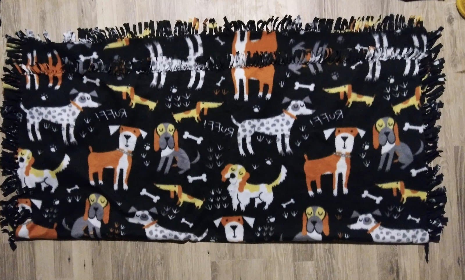 LARGE DOGS, BONES, RUFF! ON BLACK BACKGROUND FLEECE FABRIC . 54x46 - Image 1
