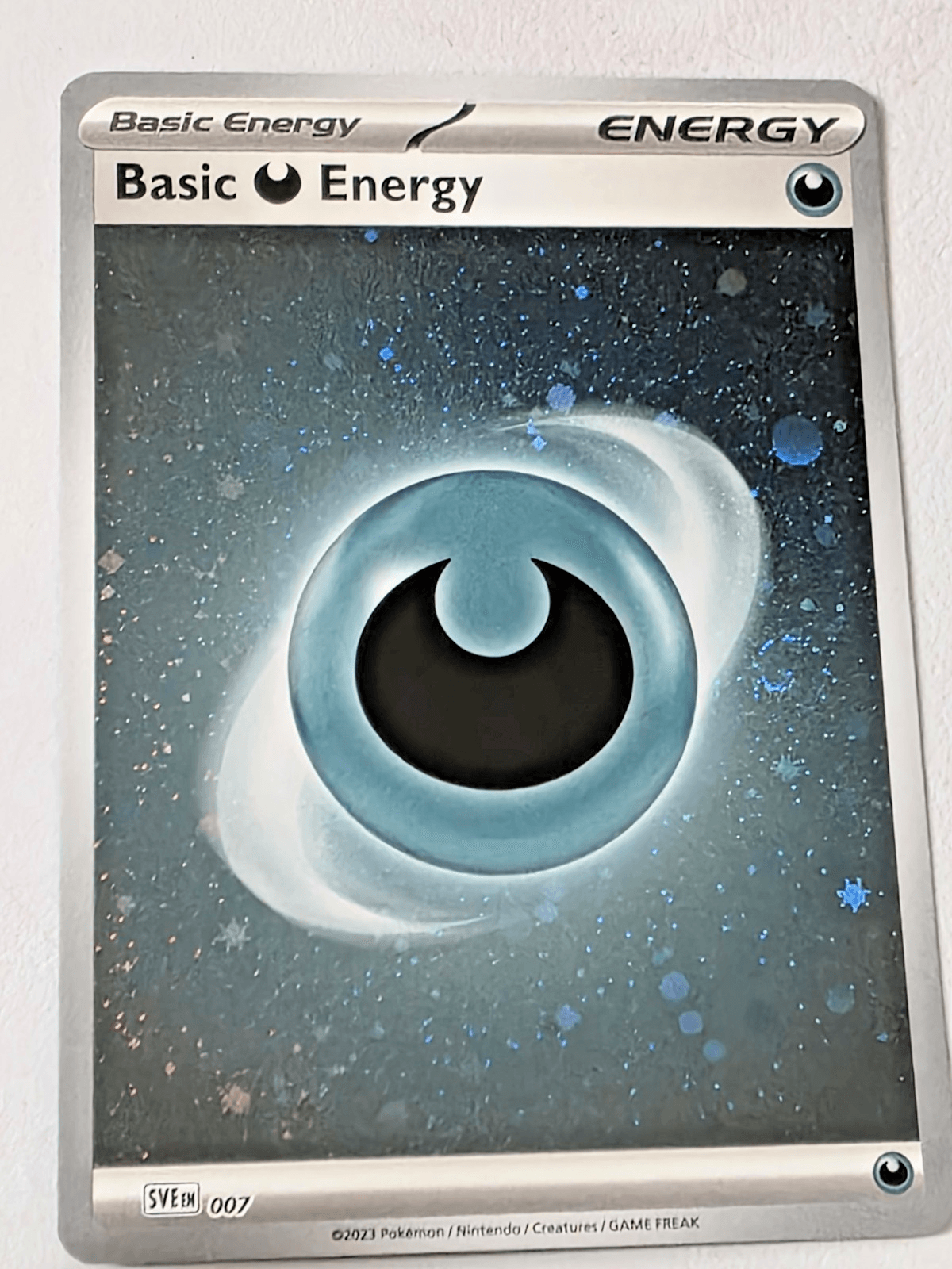 Pokemon TCG Basic Darkness Energy Cosmos Holo with Swirl SVE 007