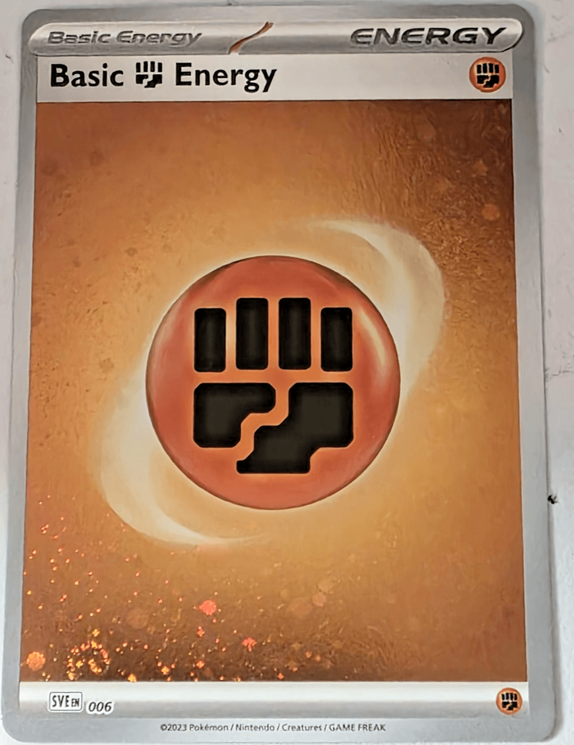 Pokemon TCG Basic Fighting Energy Cosmos with Swirls Holo 006 NM