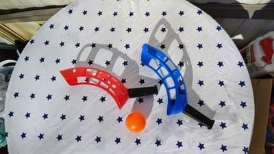 Ball Toss Game Set with Red and Blue Launchers and Orange Ball - Image 1
