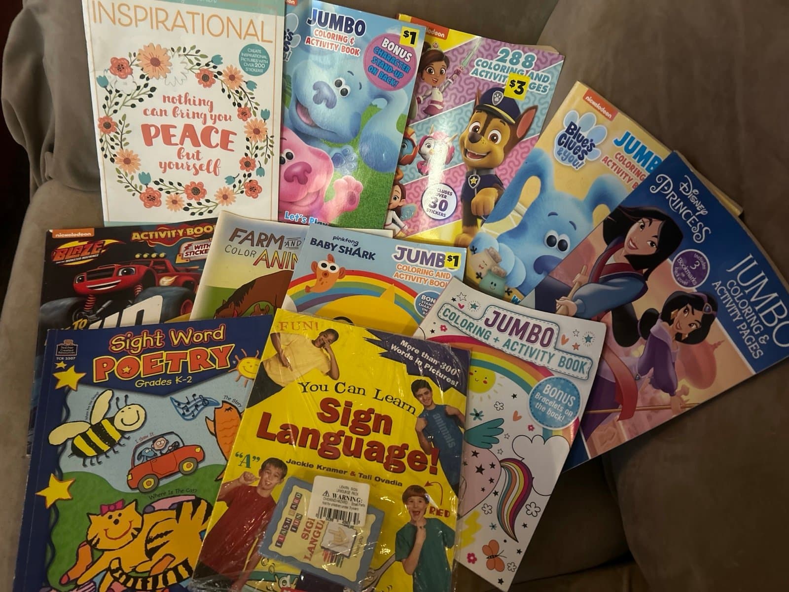 BOX FULL OF ACTIVITY AND STICKER BOOKS AND SIGN LANGUAGE.