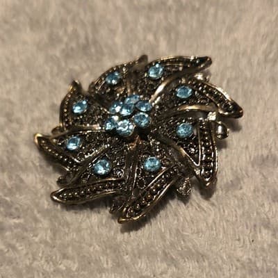 Silver Tone Flower Brooch with Blue Rhinestone Round Stones Floral Design - Image 1