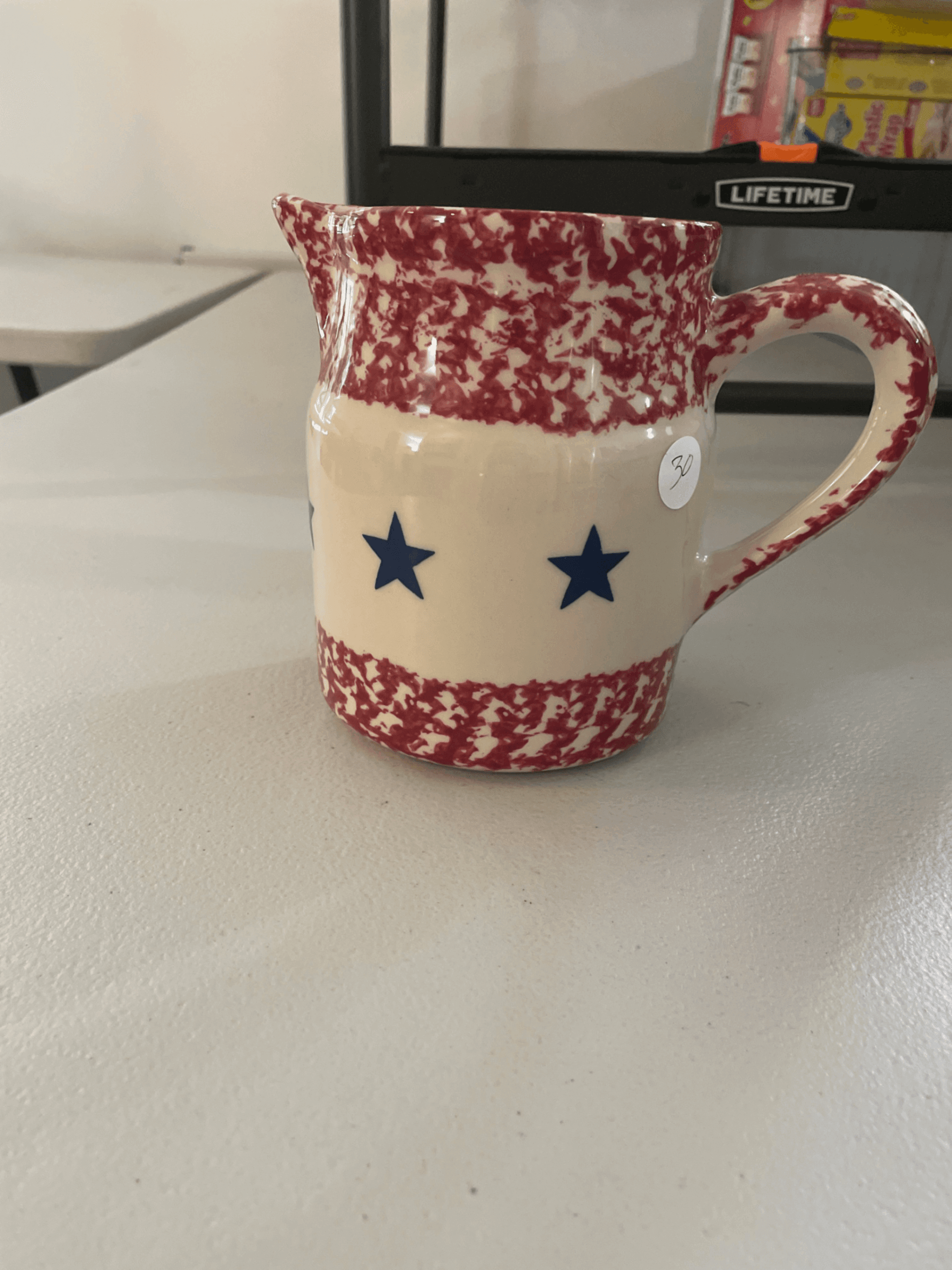 Red and Cream Ceramic Pitcher with Blue Stars - Image 1
