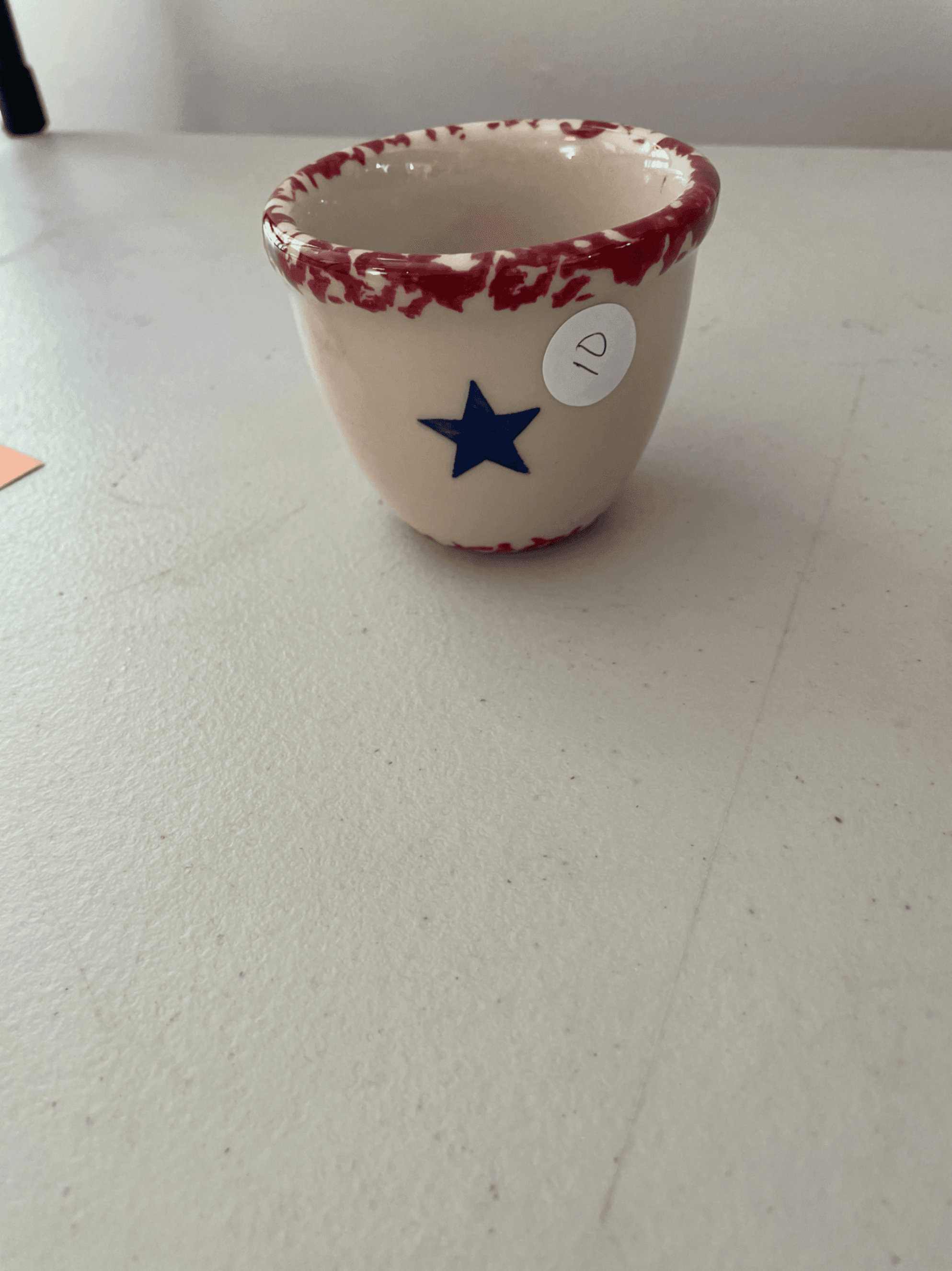 Ceramic Mug with Red Rim and Blue Star Design - Image 1