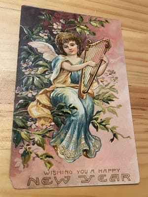 Vintage Embossed New Year Postcard Printed in Germany Angel Harp Floral Used - Image 1