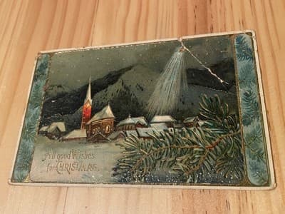 Vintage Christmas Postcard Printed in Germany Embossed Village Star Postmark - Image 1