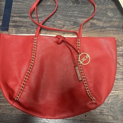 BCBG RED PEBBLED HANDBAG. gold Chain Accents, Leather. 18" Wide, 11"height - Image 1