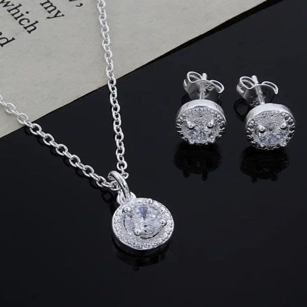 The Dainty Solitaire pendant necklace and stud earrings set in sterling silver - Image 1