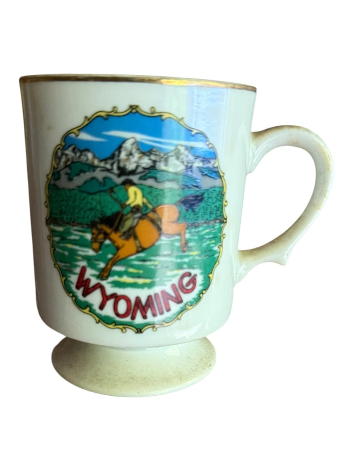 VTG Wyoming Souvenir Coffee Mug Horse Cowboy Graphics Gold Trim White Ceramic - Image 1