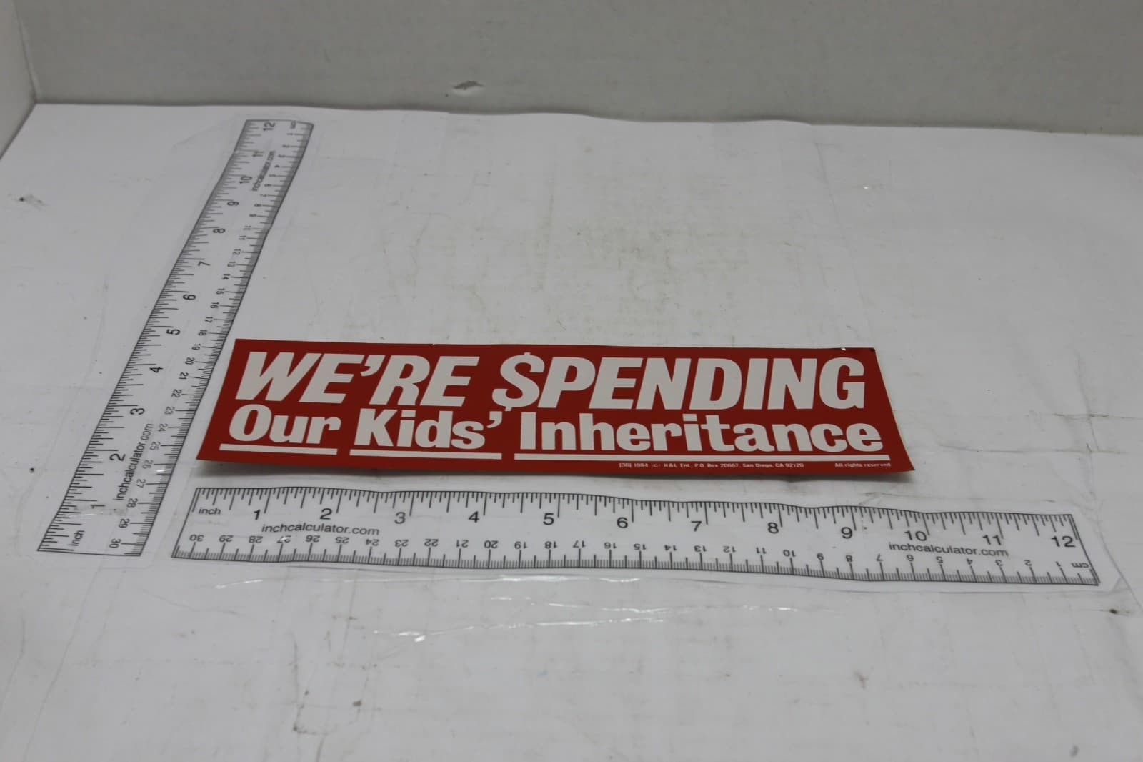 10in x 3in Bumper Sticker "Were $pending over kids inheritance" Red & White - Thumbnail 2