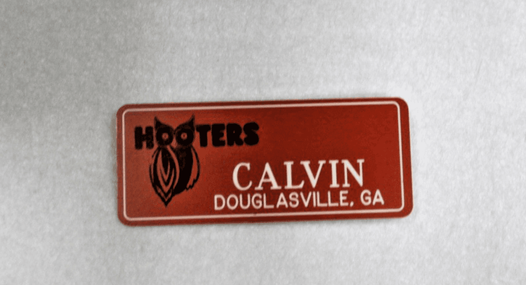 HOOTERS RESTAURANT MENS CALVIN ORANGE NAME TAG (PIN) - Image 1