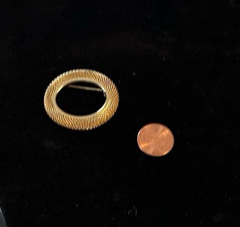 Vintage gold toned oval brooch