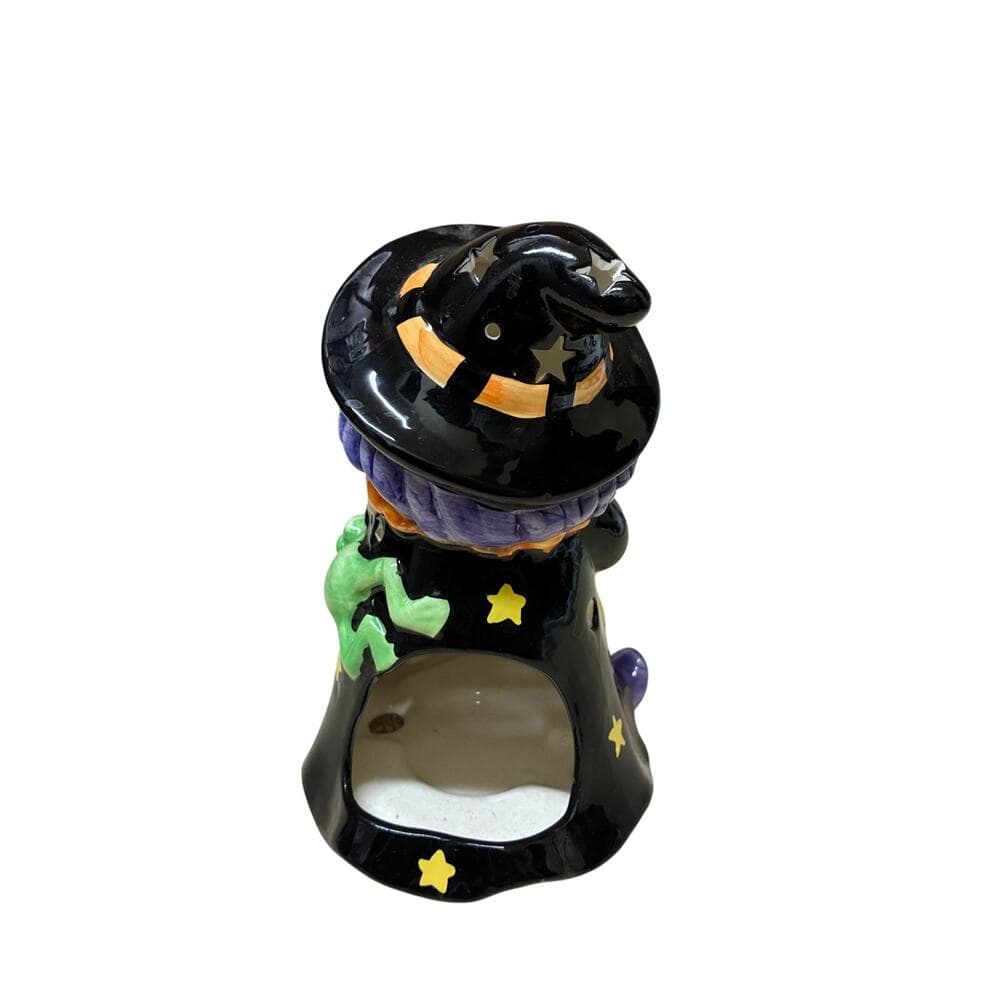 vintage-style ceramic Halloween figurine featuring a witch holding a broom