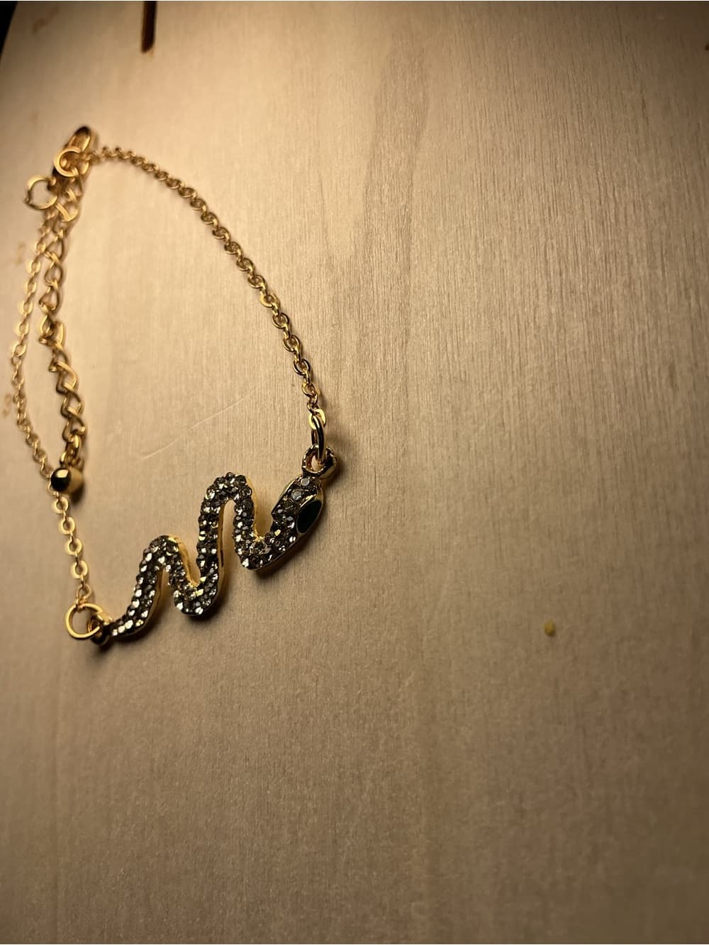 Gold Tone Snake Pendant Bracelet with Black Crystal Accent