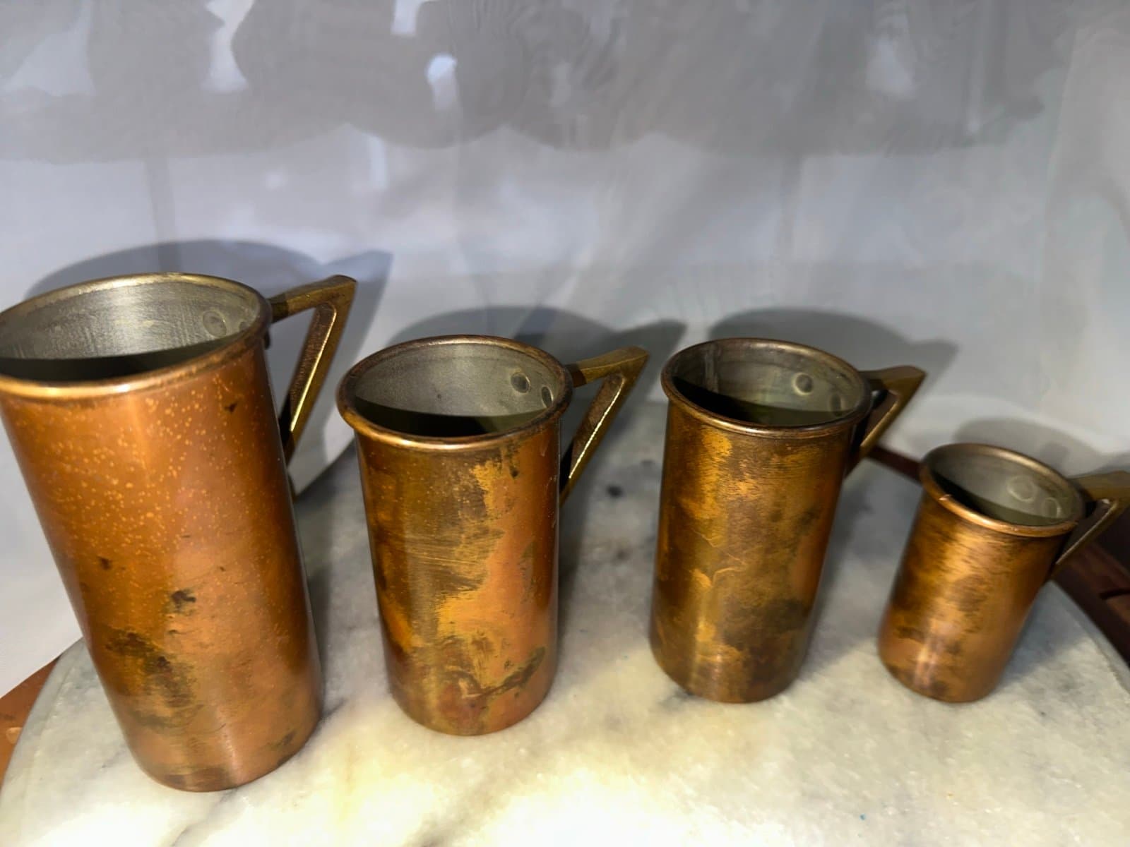 4 antique 1920s copper measuring cups with brass handles