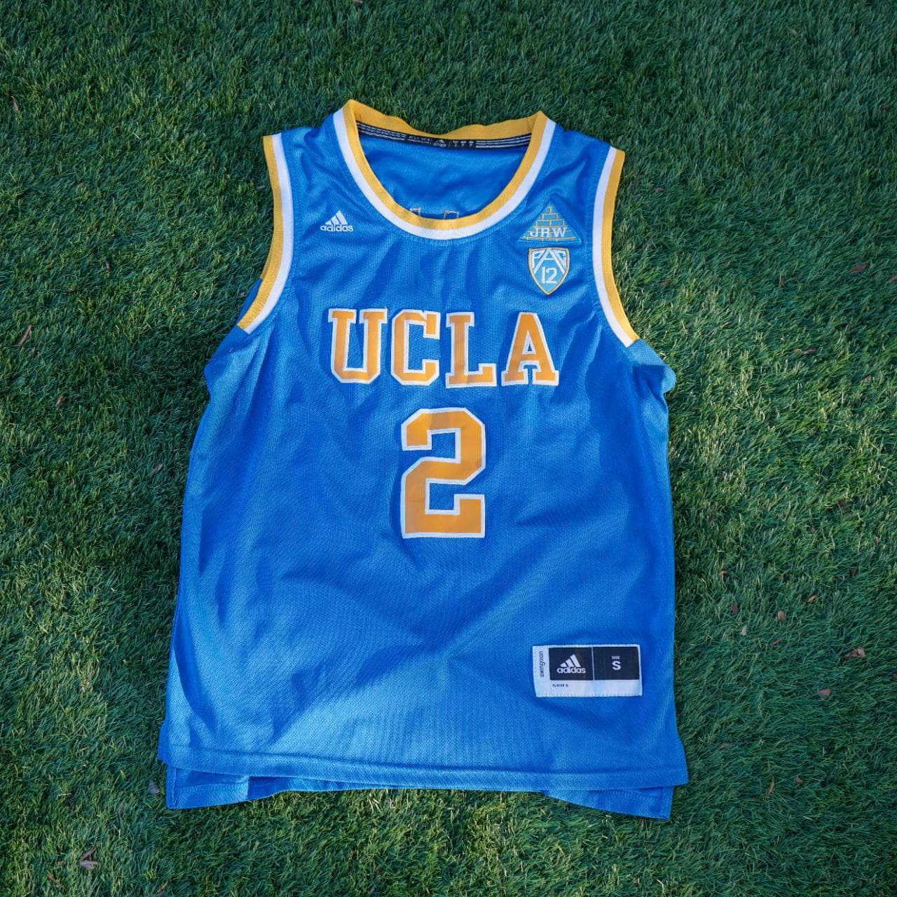 Adidas NCAA UCLA (2) Ball jersey in powder blue and gold. Size adult small. Features stitched graphics on the front and the back.