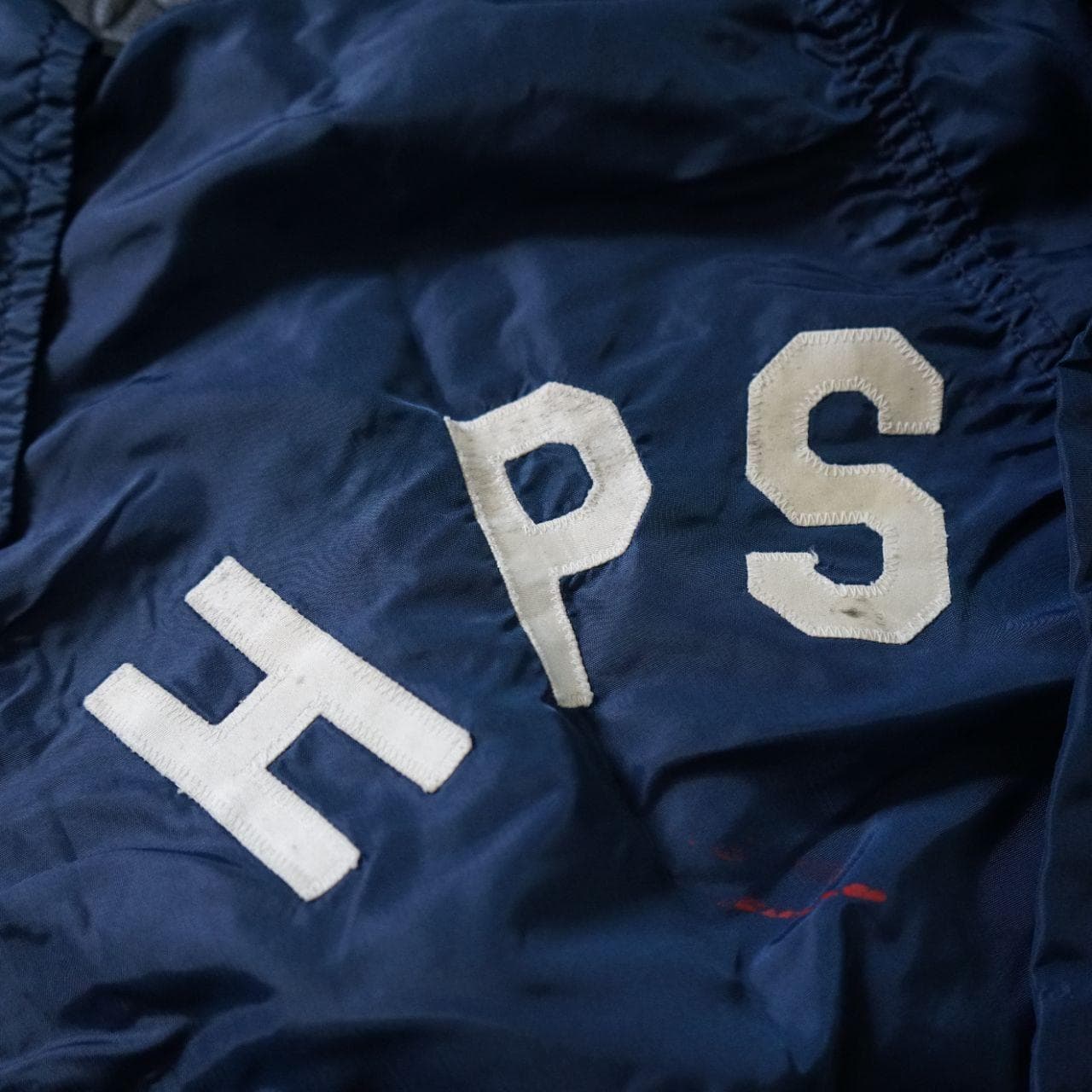 Vintage Coaches jacket in navy with button closure. The jacket is estimated to be from the 70/80s collected in Maryland. No size tag, but fits like an L or XL. Features authentic vintage aging throughout and elastic sleeve closures. - Thumbnail 3