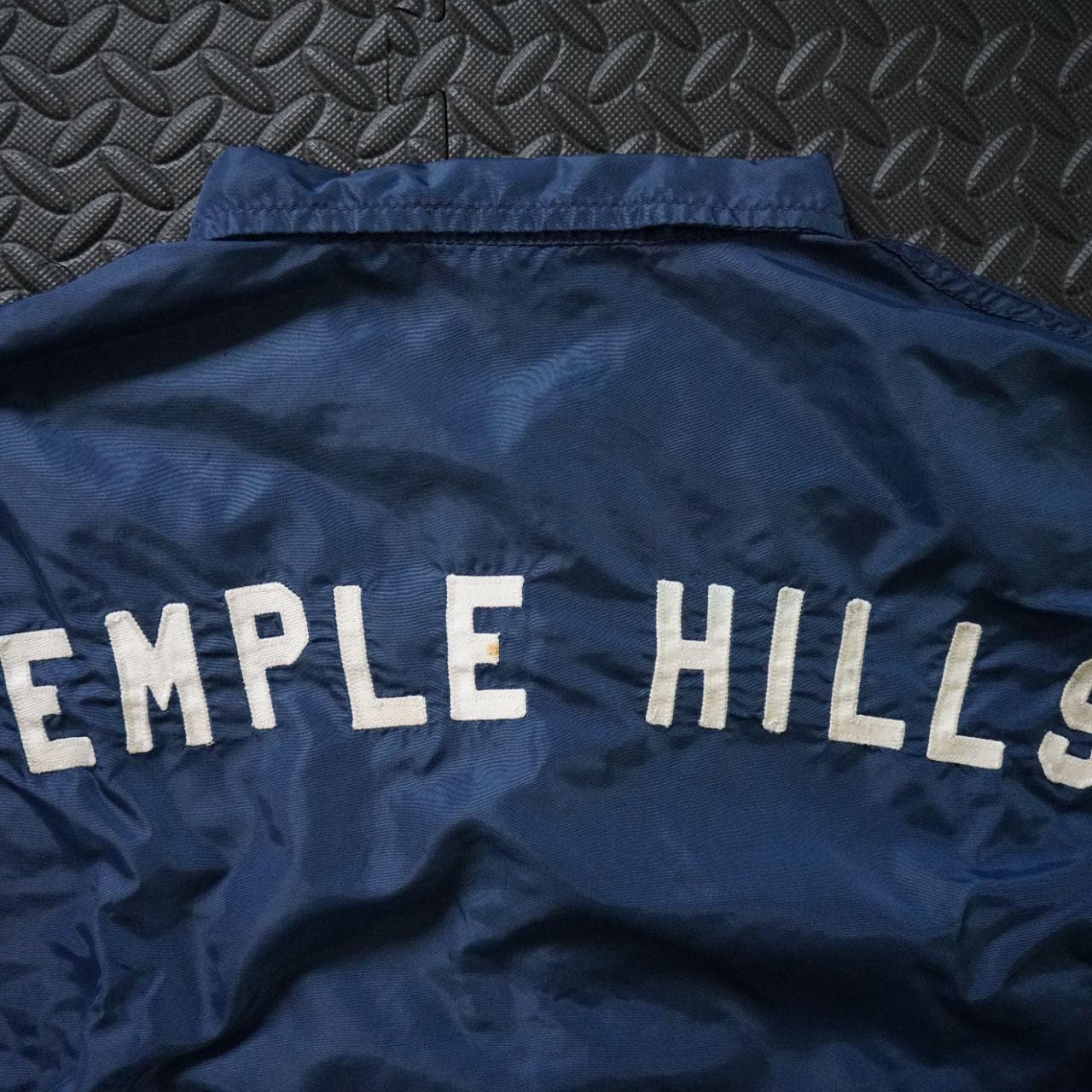 Vintage Coaches jacket in navy with button closure. The jacket is estimated to be from the 70/80s collected in Maryland. No size tag, but fits like an L or XL. Features authentic vintage aging throughout and elastic sleeve closures. - Thumbnail 5