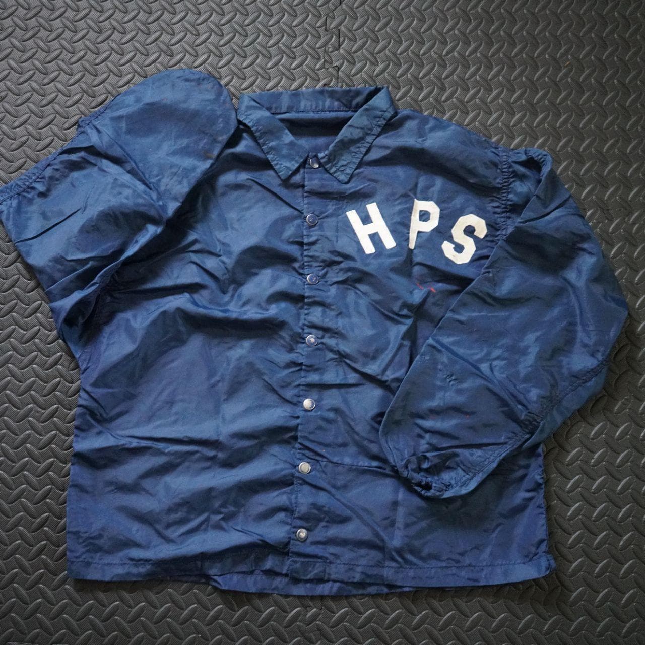 Vintage Coaches jacket in navy with button closure. The jacket is estimated to be from the 70/80s collected in Maryland. No size tag, but fits like an L or XL. Features authentic vintage aging throughout and elastic sleeve closures. - Thumbnail 2