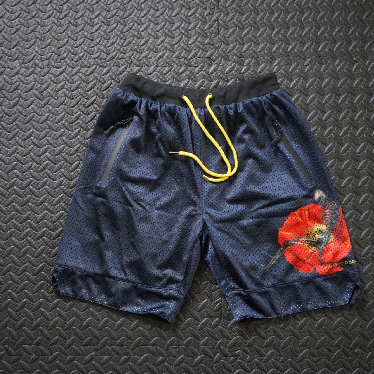 Ricardo D'Sean, DC Based streetwear brand, basketball shorts in adult small. Basketball shorts feature heavy mesh, a drawstring waistband, and zippered pockets. Shorts are also reversible and all black on the other side.