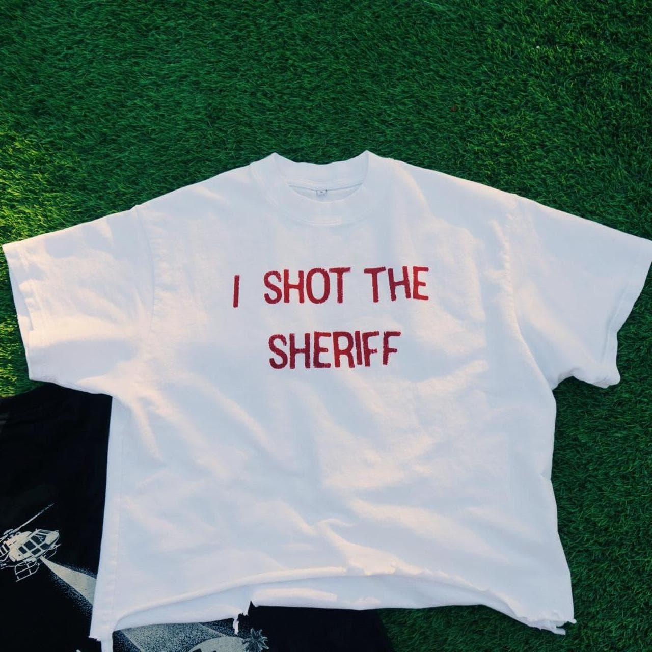 I Shot The Sheriff distressed hem tee by Neon Gymnasium. Features front and back graphic on a French terry white tee.