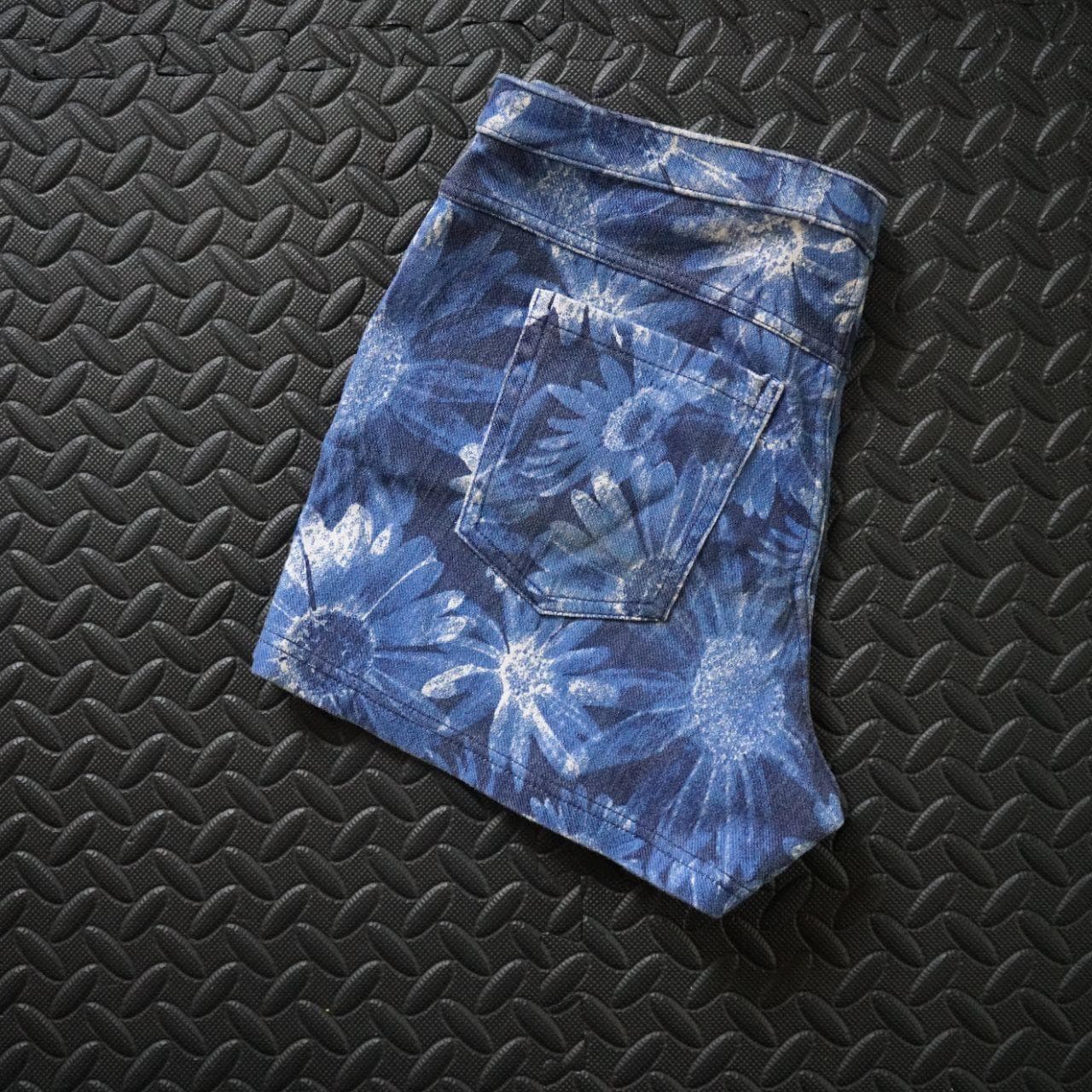 Vintage women's stretchy denim short shorts in a size medium. Super soft shorts with an elastic waistband and back pockets. Features flower pattern all over. - Thumbnail 4