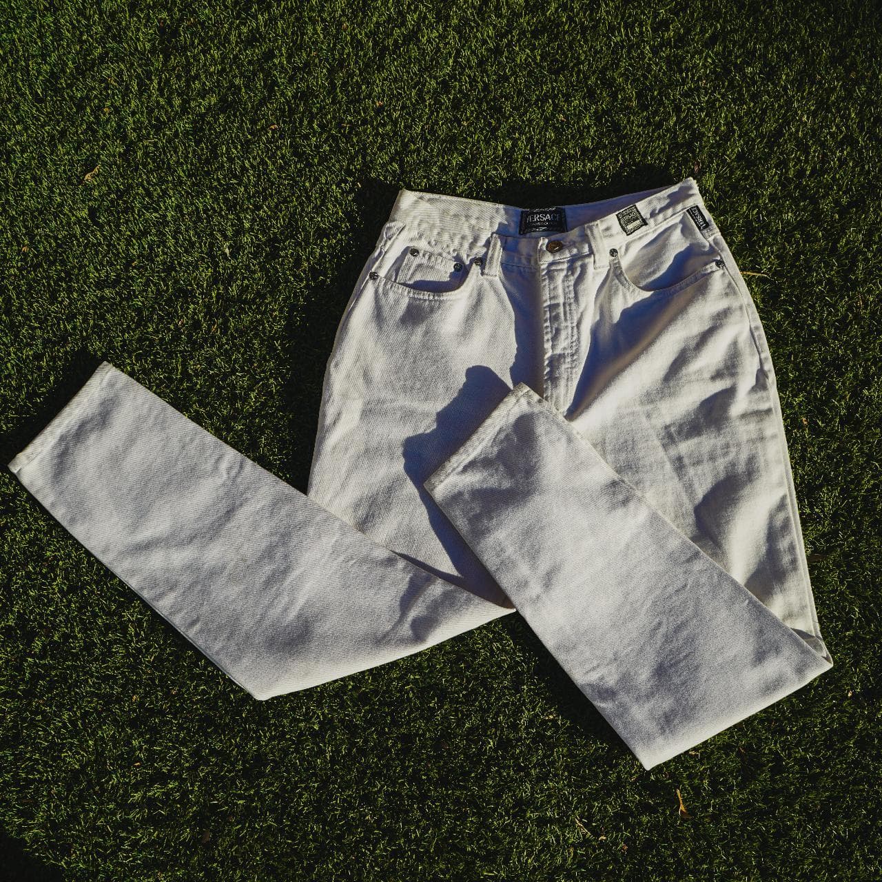 Versace white denim pants in size 34. Vintage style women's jeans that run small. Probably fits more like a 31. Features Versace logo details and original Medusa buttons. The pants are in great shape and picked locally in Los Angeles. - Thumbnail 2