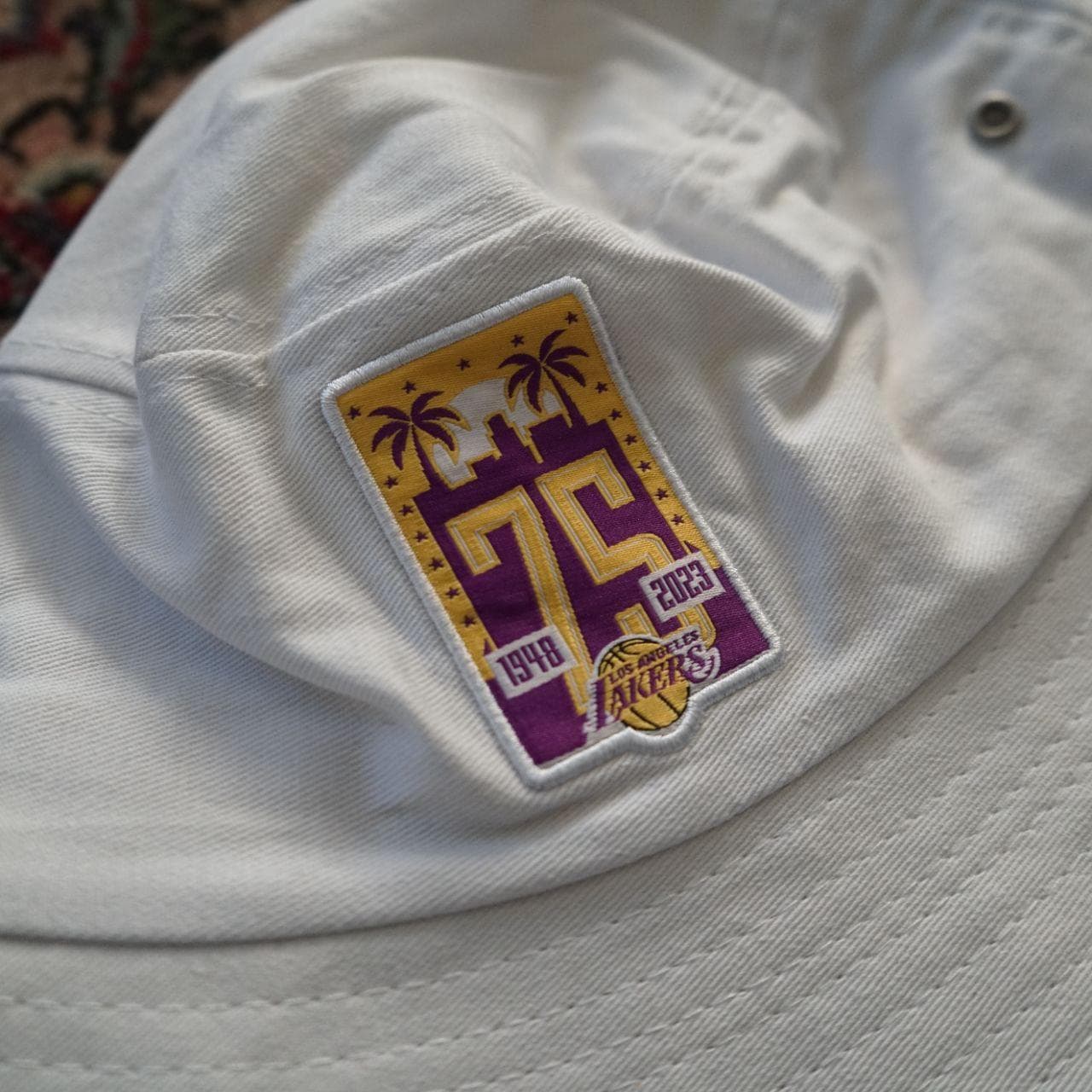 75th Anniversary edition NBA Lakers bucket hat. White hat with metal grommets and a commemorative Lakers patch. *Never worn* - Thumbnail 2