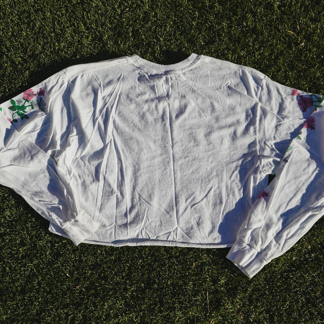 "More Self Love" long-sleeve cropped tee. Size women's medium. Features screen print text on the front and flowers on both sleeves. Seamless cropped bottom 🍉 - Thumbnail 3