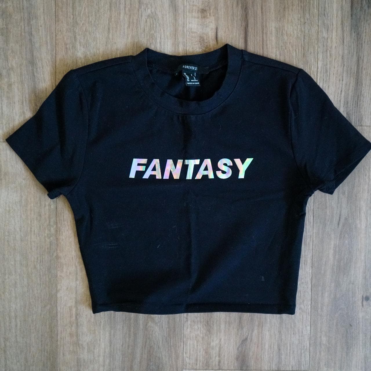 Fantasy crop top in black with holographic text. Stretchy fabric, women's size small.